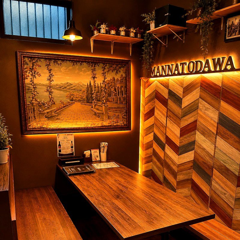 Private dining booth with warm lighting and artwork at Mannat